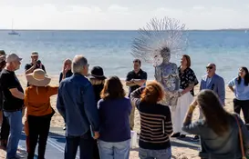 a group of people standing on a beach