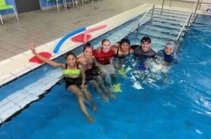 Adults participating in a swimming class.