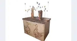 a wood box with birds on it