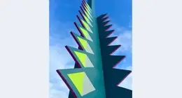 a tall green and yellow sculpture