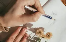 a person drawing on a book