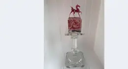 a glass statue of a horse on a glass stand