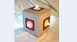 a cube shaped light fixture with lights