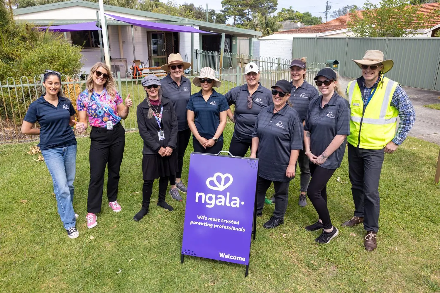 a group of people standing in a yard